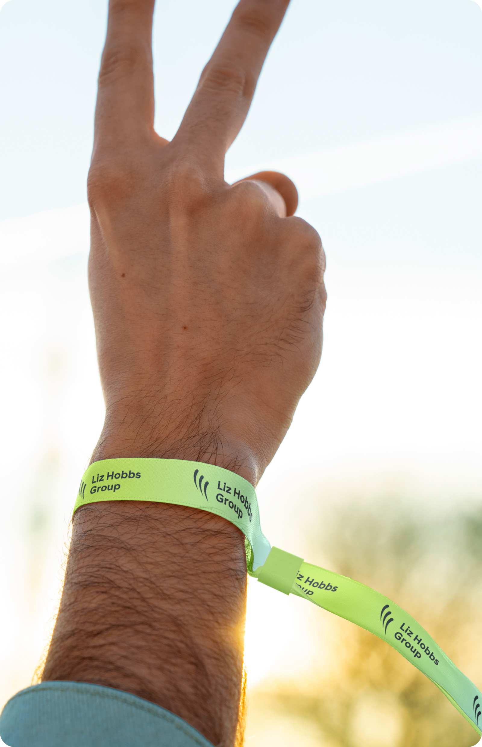 A Liz Hobbs wrist band around arm