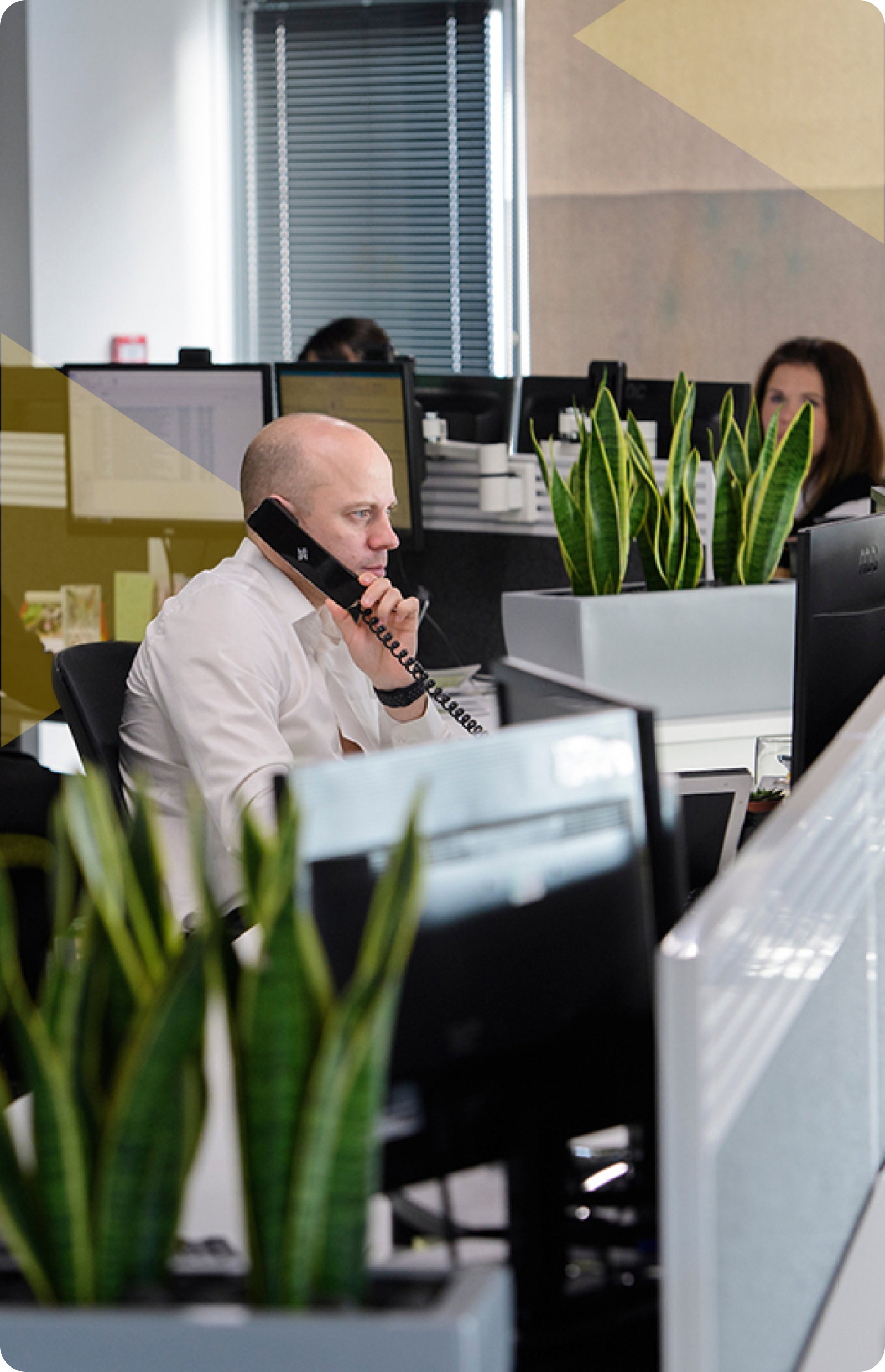 A man talking on a phone at Fletcher Longstaff Office